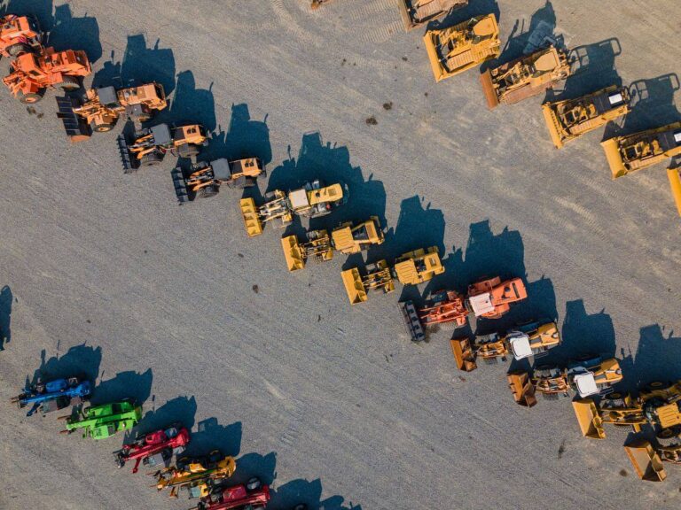 Aerial view of perfect rows of wheel loaders and other heavy machinery